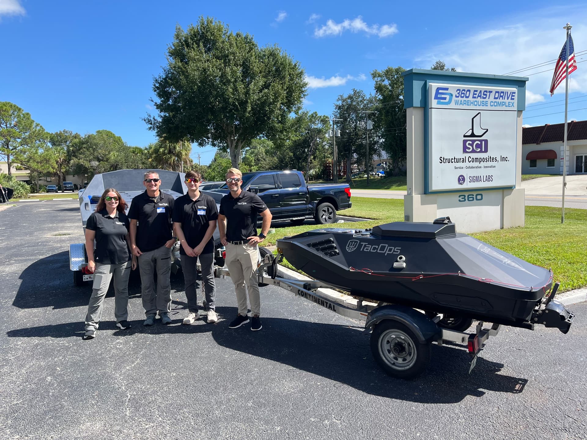 TacOps Maritime Systems team with the TOMS-9 platform outside Structural Composites