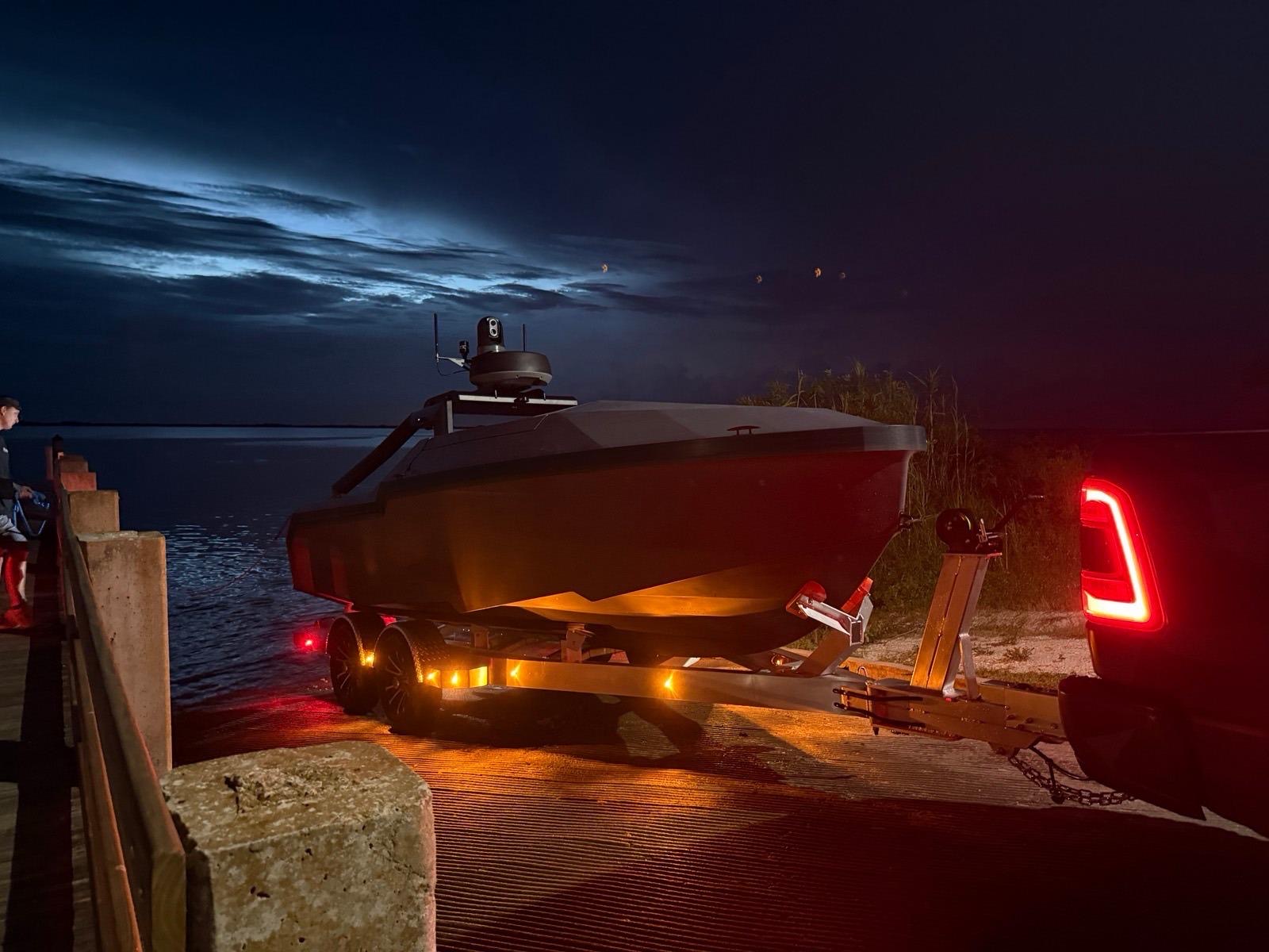TOMS-19 on its trailer at a boat ramp in the dark, backed toward the water