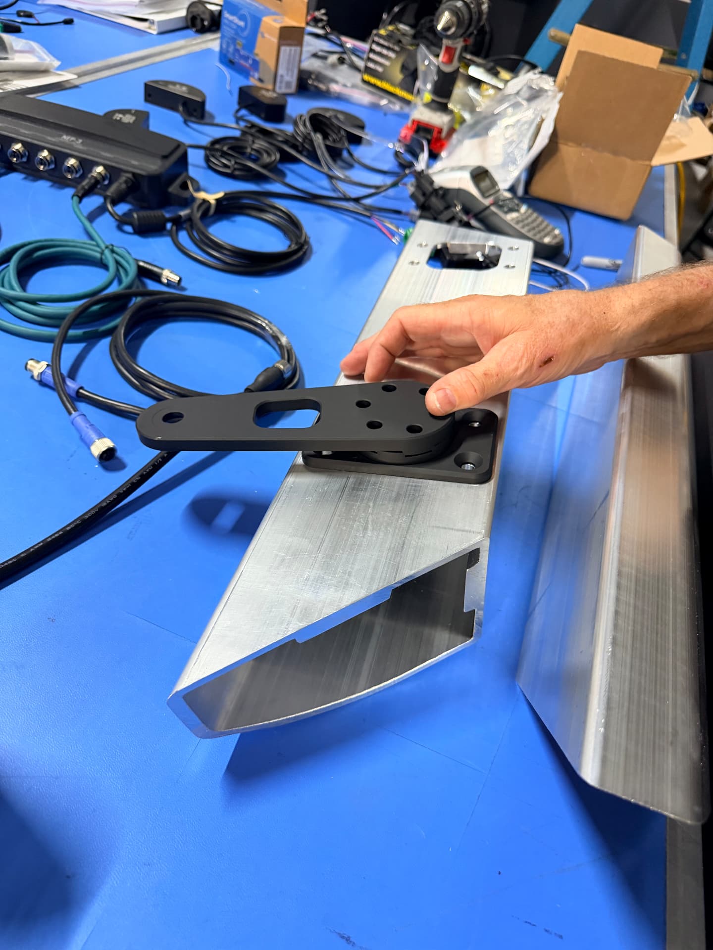 Machined TacOps hardware mounting bracket fitted during assembly